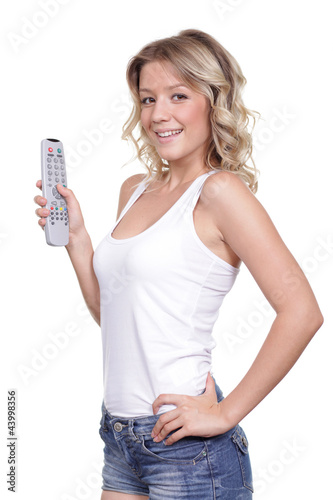 Photo: Young woman with TV remote control Young woman with TV remote control