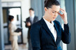 young businesswoman having headache at work