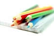 Photo : Colorful pencils with notebook on white background Colorful pencils with notebook on white background