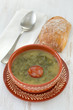 caldo verde in brown bowl and bread