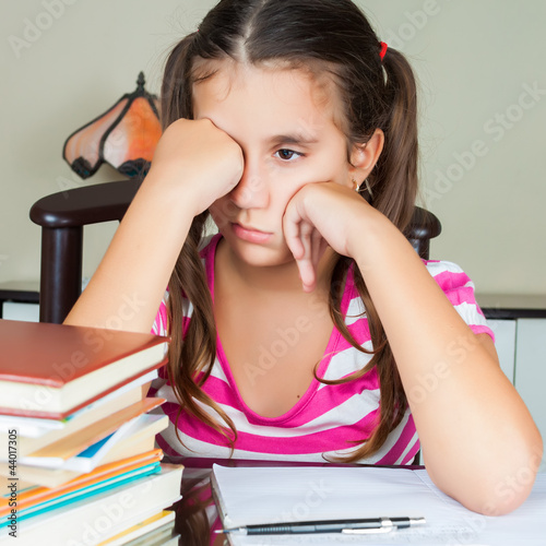 Photo: Tired hispanic schoolgirl with a sleepy face Tired hispanic schoolgirl with a sleepy face