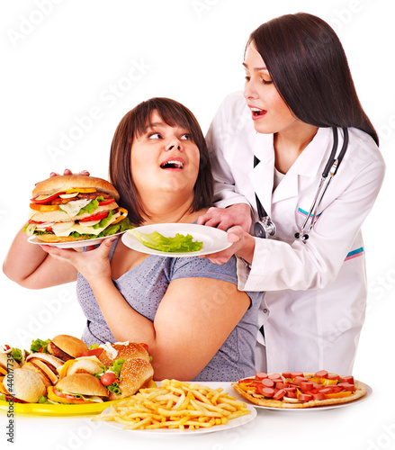 Photo: Woman with hamburger and doctor. Woman with hamburger and doctor.