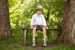 Fair-haired boy in a hat, shirt, shorts
