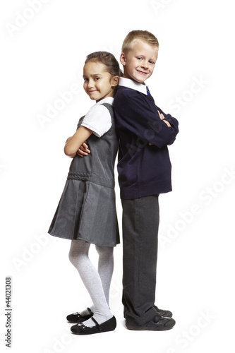 Photo: School boy and girl on white background School boy and girl on white background