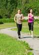 Woman and man jogging in park
