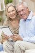 Happy Senior Man & Woman Couple Using Tablet Computer