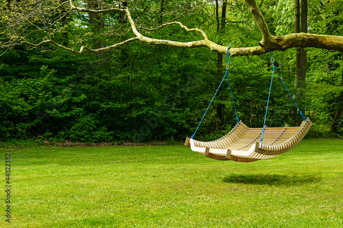 Photo: Swing bench in lush garden Swing bench in lush garden