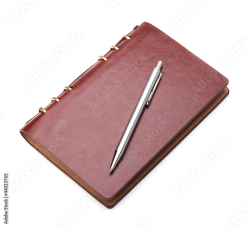 Photo: Brown notepad and pen on white background with soft shadow Brown notepad and pen on white background with soft shadow