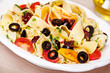 Pappardelle pasta with cherry tomatoes, olives and zucchini