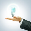 Foto: Saver Lightbulb on businessman hend Saver Lightbulb on businessman hend