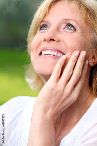 Photo: Beautiful aged woman in the park Beautiful aged woman in the park