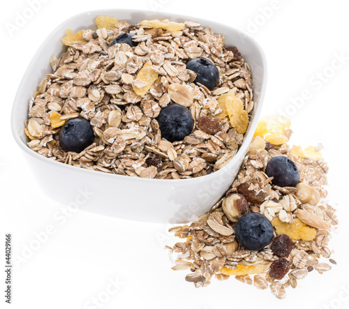 Photo: Mixed Muesli in a bowl isolated on white Mixed Muesli in a bowl isolated on white