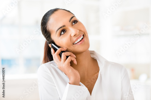 Photo: Closeup portrait of beuatiful indian businesswoman talking using Closeup portrait of beuatiful indian businesswoman talking using