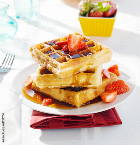 Photo: breakfast - waffles with syrup and strawberries breakfast - waffles with syrup and strawberries