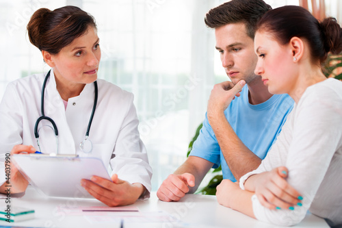Photo: Doctor consults a young couple Doctor consults a young couple