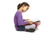Photo: School girl sitting reading book School girl sitting reading book