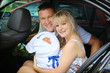 Photo: Happy family with newborn in car Happy family with newborn in car
