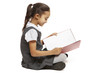 Photo: School girl sitting reading book School girl sitting reading book
