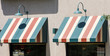Green Lamps Over Striped Awnings