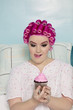 Tempted woman looking at cupcake