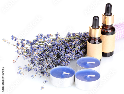 Photo: Lavender flowers with aroma oils and candles isolated on white Lavender flowers with aroma oils and candles isolated on white