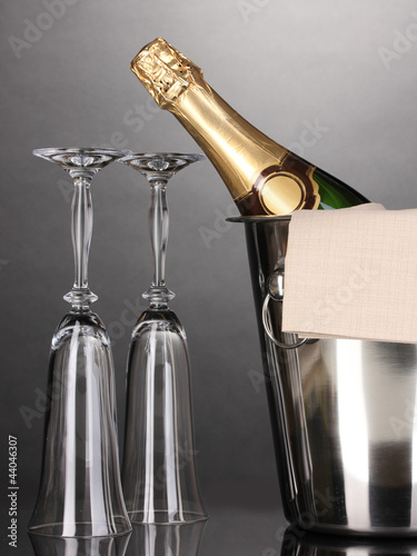 Photo: Champagne bottle in bucket with ice and glasses Champagne bottle in bucket with ice and glasses