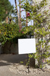 Photo: Real estate sign board outside house Real estate sign board outside house