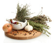 dried herbs in mortar and vegetables, isolatrd on white