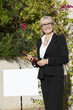 Photo: Portrait of a senior real estate agent standing by signboard Portrait of a senior real estate agent standing by signboard