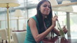 Beautiful happy woman drinking cocktail in cafe, steadicam shot
