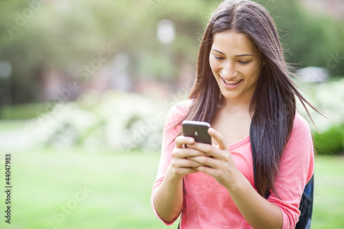 Photo: Hispanic college student texting Hispanic college student texting
