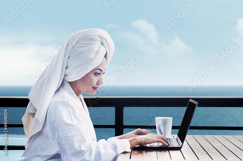 Photo: Asian woman using laptop Asian woman using laptop