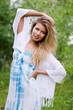The beautiful woman in a blue dress in the field