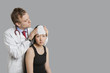 Doctor adjusting bandage on patient's head
