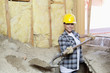 Portrait of a happy female contractor digging sand at construction site