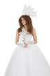 Beautiful woman in wedding dress holding crucifix over white background