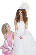 Beautiful young bride with bridesmaid over white background