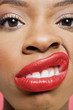 Close-up portrait of young woman with red lips grimacing