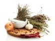 dried herbs in mortar and vegetables, isolatrd on white