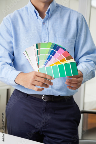Foto : Interior Designer Holding Color Swatches Interior Designer Holding Color Swatches