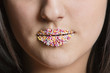 Cropped image of Caucasian woman with sprinkle candy lips