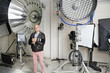 Senior photographer with camera and light reflectors in studio