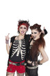 Photo: Arrogant punk females showing middle finger over white background Arrogant punk females showing middle finger over white background