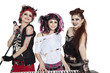 Beautiful young punk woman with piano and microphone over white background