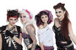 Portrait of all female rock band with microphone over white background