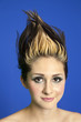 Photo: Portrait of a beautiful young woman with spiked hair over colored background Portrait of a beautiful young woman with spiked hair over colored background
