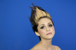 Photo: Portrait of beautiful young woman with spiked hair posing over blue background Portrait of beautiful young woman with spiked hair posing over blue background