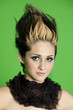 Photo: Portrait of beautiful young woman wearing scarf with spiked hair over green background Portrait of beautiful young woman wearing scarf with spiked hair over green background