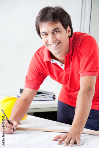 Photo: Architect Working on Blueprints Architect Working on Blueprints