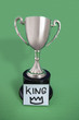 Trophy with sticky note over colored background